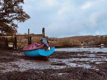 Nautical vessel on beach against sky