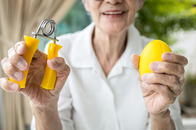 Close-up of woman holding orange