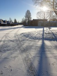 Snow covered road against sky