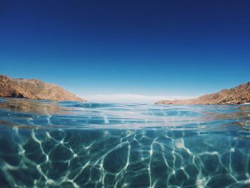 Scenic view of sea against blue sky