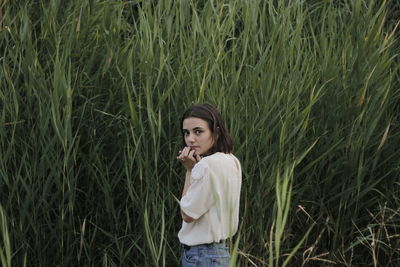 Young woman looking away on field