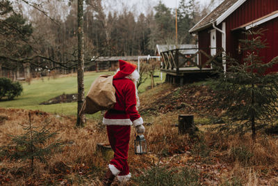 Man wearing santa costume carrying sack