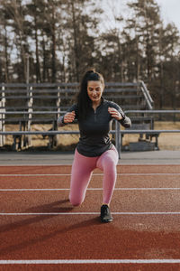 Woman exercising at running track