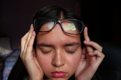 Close-up portrait of young woman with eyes closed