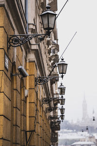 Low angle view of street light against buildings