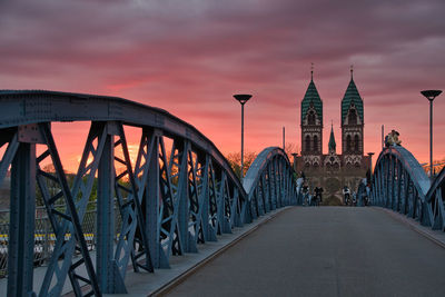 Bridge over river against sky during sunset