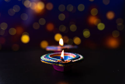 Close-up of lit candles in the dark