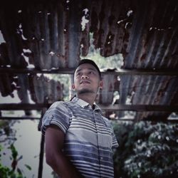 Low angle view of young man looking away