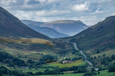 Scenic view of mountains against cloudy sky