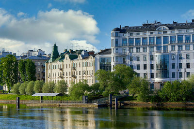 Buildings in city against cloudy sky