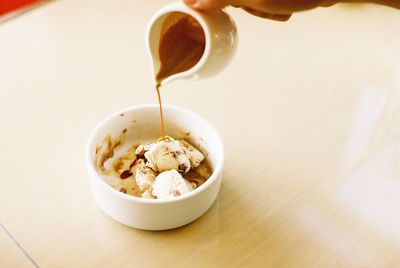 Cropped image of person preparing affogato at home