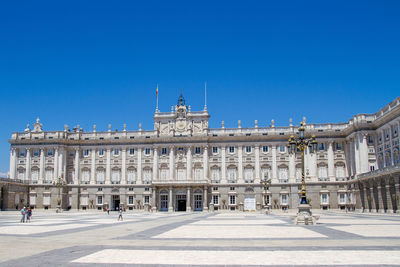 Buildings in city against blue sky