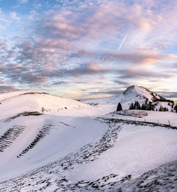 Scenic view of snowcapped mountains against sky during winter