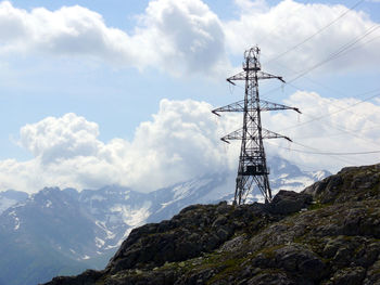 Low angle view of electricity pylon against sky