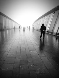 People in corridor against sky