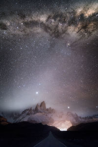 Scenic view of mountains against sky at night