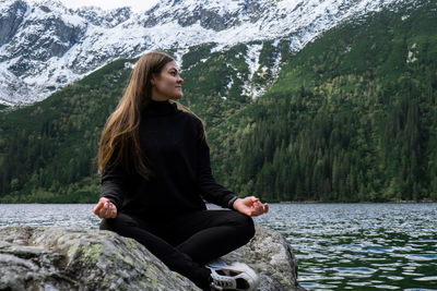 Portrait of woman sitting on rock