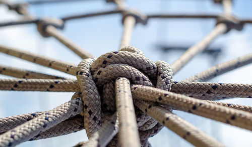 Low angle view of rope tied up on rusty metal