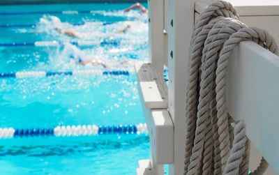 Close-up of ropes on railing by swimming pool