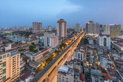 High angle view of street amidst buildings in city against sky