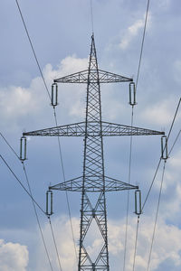 Low angle view of electricity pylon against sky