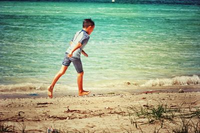 Boy standing on beach