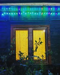 Yellow closed door of building at night