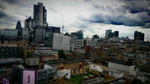 Cityscape against cloudy sky