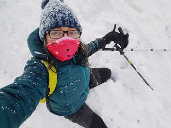 Portrait of woman skiing on snow covered land