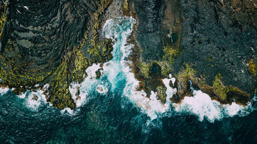 Aerial view of waves rushing at beach