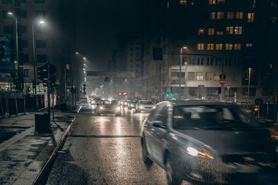 Illuminated city street and buildings at night