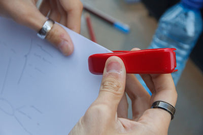 Cropped hands of woman stapling paper