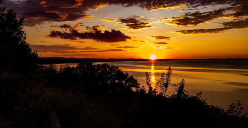 Scenic view of lake against romantic sky at sunset