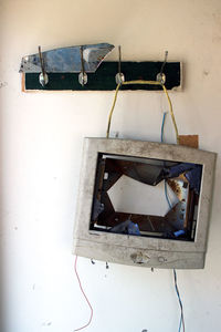 Abandoned electric lamp hanging on wall