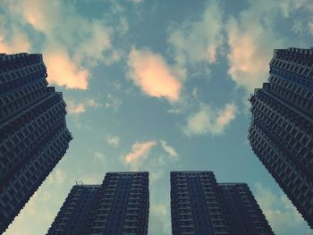 Low angle view of modern building against cloudy sky