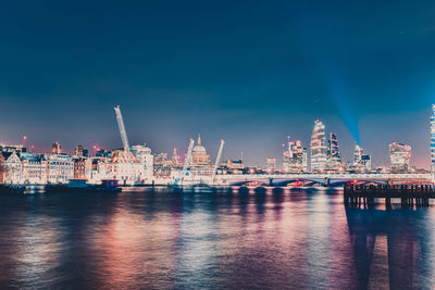 Illuminated city at waterfront