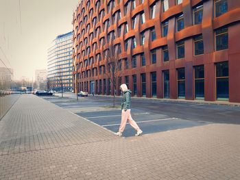 Rear view of woman walking at beach