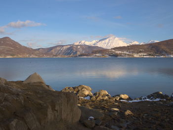 Scenic view of lake and mountains against sky