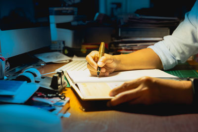 Cropped hands of man working on table