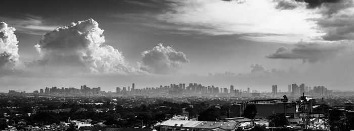 High angle view of buildings against cloudy sky