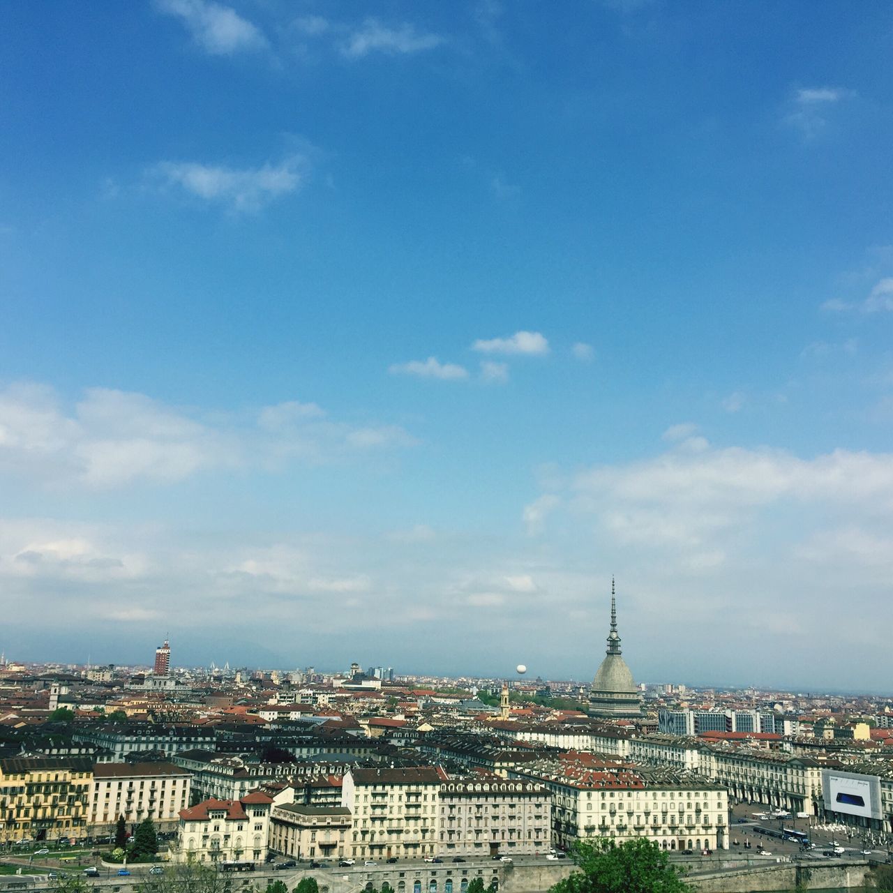 architecture, built structure, cityscape, city, sky, residential district, cloud - sky, residential building, blue, cloud, city life, outdoors, capital cities, travel destinations, day, town, no people, cloudy, townscape, nature, tourism, horizon over land