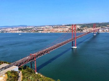 High angle view of bridge over sea against buildings
