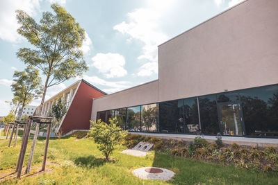 Houses and trees against sky on sunny day