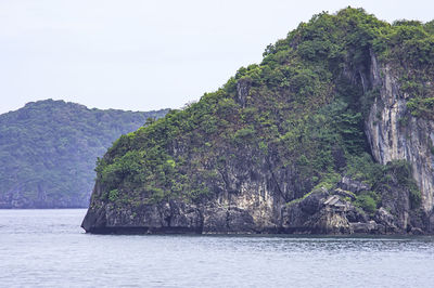 Rock formations by sea against sky