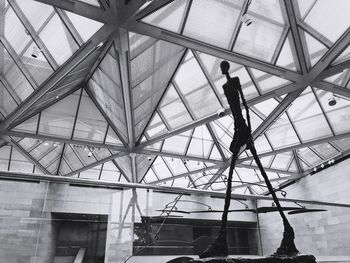 Low angle view of man walking on roof