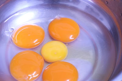 Close-up of yellow eggs in container