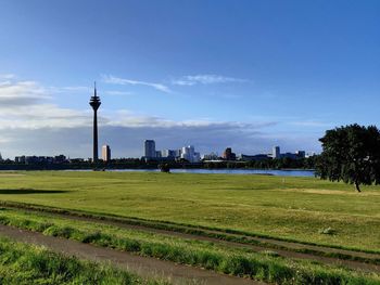 View of tower on field against cloudy sky