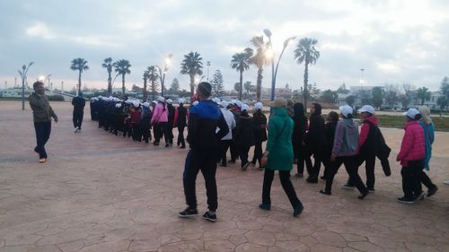 People on street against sky