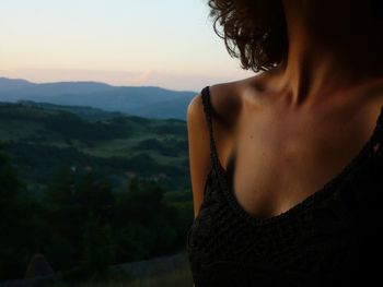 Woman with arms outstretched in background