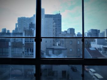 Reflection of buildings on glass window